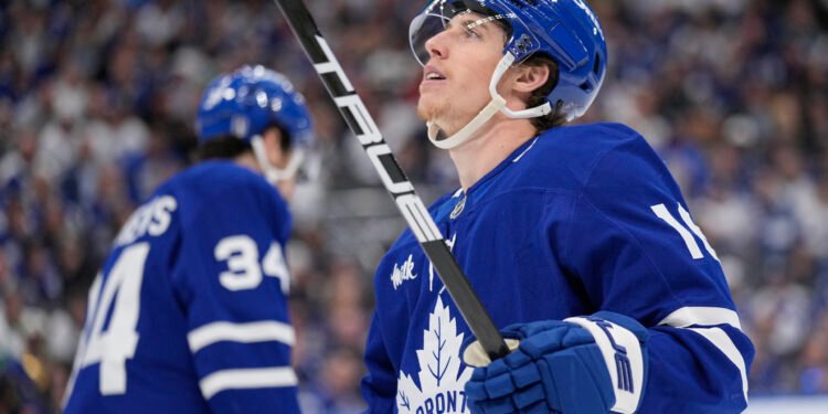 May 18, 2025; Toronto, Ontario, CAN; Toronto Maple Leafs forward Mitch Marner (16) looks up at the scoreboard as Toronto Maple Leafs forward Auston Matthews (34) skates to the bench during the third period of game seven of the second round of the 2025 Stanley Cup Playoffs against the Florida Panthers at Scotiabank Arena. Mandatory Credit: John E. Sokolowski-Imagn Images