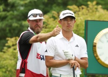 Jun 14, 2025; Oakmont, Pennsylvania, USA; Collin Morikawa and his caddie Joe Greiner look down the first fairway during the third round of the U.S. Open golf tournament. Mandatory Credit: Charles LeClaire-Imagn Images