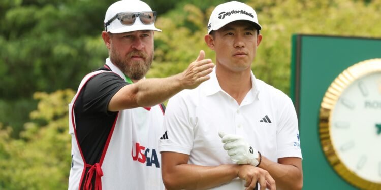 Jun 14, 2025; Oakmont, Pennsylvania, USA; Collin Morikawa and his caddie Joe Greiner look down the first fairway during the third round of the U.S. Open golf tournament. Mandatory Credit: Charles LeClaire-Imagn Images