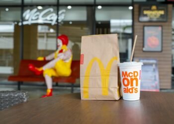 BANGKOK,THAILAND - SEPTEMBER 6,2018 : McDonald's paper bag and cold drink on desk in front of McCafe