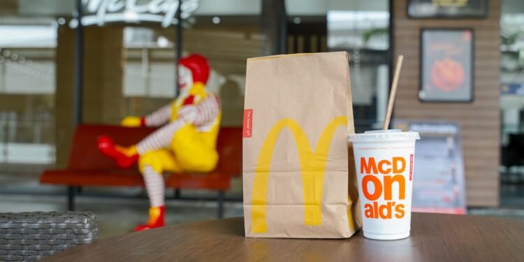 BANGKOK,THAILAND - SEPTEMBER 6,2018 : McDonald's paper bag and cold drink on desk in front of McCafe
