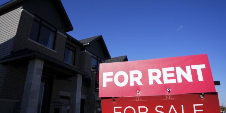A for-rent and a for-sale sign are displayed on a house in a new housing development in Ottawa on Friday, Oct. 14, 2022. The national average asking rent in May was down 3.3 per cent from a year earlier at $2,129, marking the eighth consecutive month of year-over-year decreases. THE CANADIAN PRESS/Sean Kilpatrick