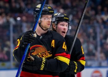 Jan 21, 2025; Vancouver, British Columbia, CAN; Vancouver Canucks forward Elias Pettersson (40) talks with forward Brock Boeser (6) against the Buffalo Sabres in the second period at Rogers Arena. Mandatory Credit: Bob Frid-Imagn Images