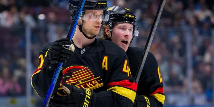 Jan 21, 2025; Vancouver, British Columbia, CAN; Vancouver Canucks forward Elias Pettersson (40) talks with forward Brock Boeser (6) against the Buffalo Sabres in the second period at Rogers Arena. Mandatory Credit: Bob Frid-Imagn Images
