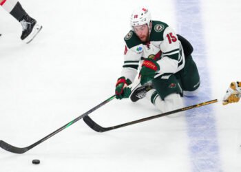 Apr 29, 2025; Las Vegas, Nevada, USA; Minnesota Wild right wing Justin Brazeau (15) plays the puck against the Vegas Golden Knights during the third period of game five of the first round of the 2025 Stanley Cup Playoffs at T-Mobile Arena. Mandatory Credit: Stephen R. Sylvanie-Imagn Images