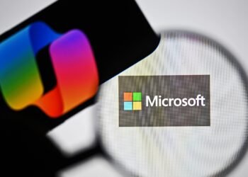 ANKARA, TURKIYE - APRIL 03: In this photo illustration the logo of Microsoft is being displayed on a laptop screen and the logo of Copilot is being displayed on a smart phone in Ankara, Turkiye on April 03, 2025. (Photo by Muhammed Abdullah Kurtar/Anadolu via Getty Images)