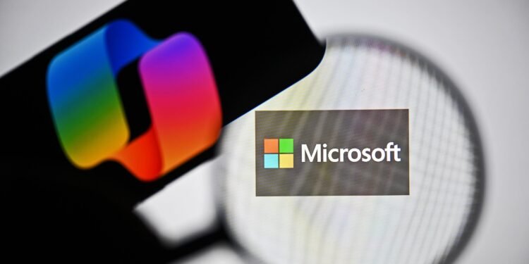 ANKARA, TURKIYE - APRIL 03: In this photo illustration the logo of Microsoft is being displayed on a laptop screen and the logo of Copilot is being displayed on a smart phone in Ankara, Turkiye on April 03, 2025. (Photo by Muhammed Abdullah Kurtar/Anadolu via Getty Images)