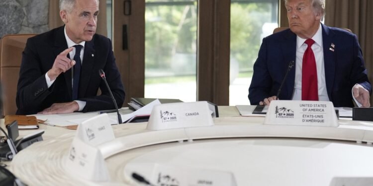 President Donald Trump, right, and Canada's Prime Minister Mark Carney participate in a session of the G7 Summit, Monday, June 16, 2025, in Kananaskis, Canada. (AP Photo/Mark Schiefelbein)