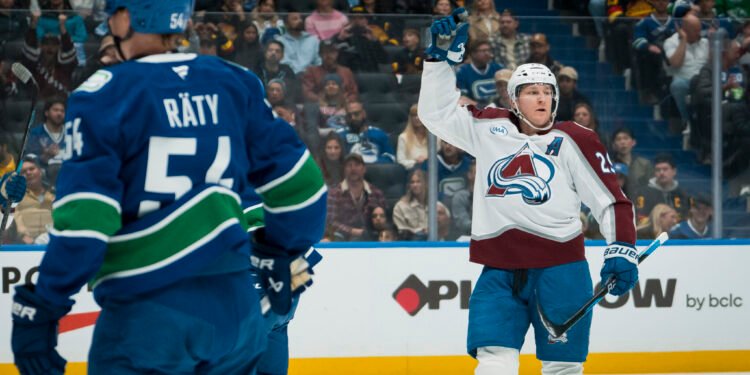 Nov 9, 2025; Vancouver, British Columbia, CAN; Vancouver Canucks forward Aatu Raty (54) and forward Kiefer Sherwood (44) react as Colorado Avalanche forward Nathan MacKinnon (29) celebrates his second goal of the game in the first period at Rogers Arena. Mandatory Credit: Bob Frid-Imagn Images