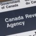 Rise in AI-Driven Tax Scams Hits Canadians During Filing Season 19 Canadian taxpayer reviewing documents amid rise in AI-driven tax scams during 2026 filing season