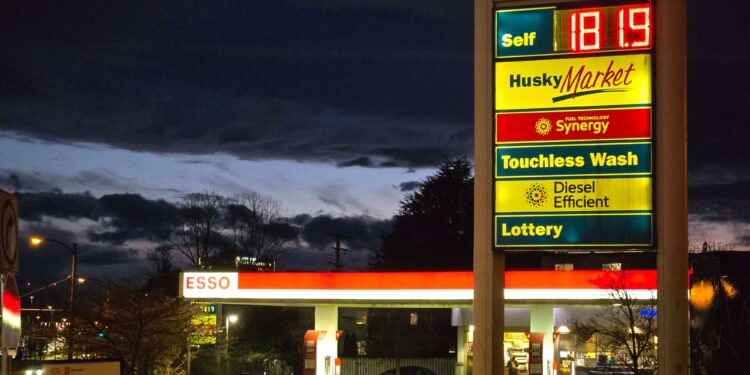 Gas station price sign showing rising fuel costs amid global oil market volatility