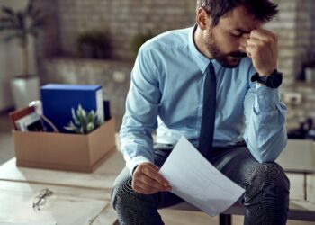 Unemployed Canadians standing in line at a job center amid rising national unemployment rate
