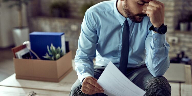 Unemployed Canadians standing in line at a job center amid rising national unemployment rate