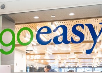 Goeasy logo with a stock market graph showing a steep decline amid loan write-down news