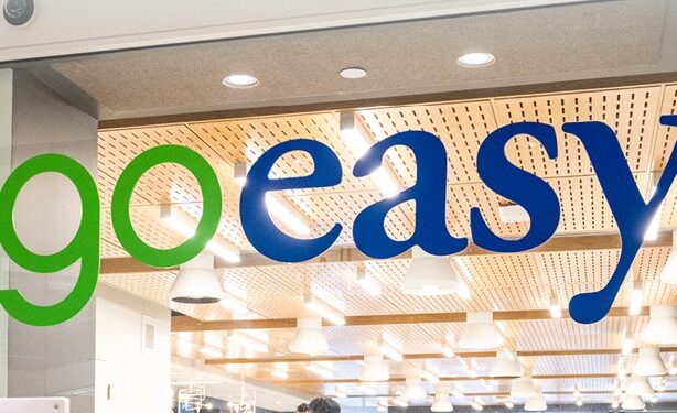 Goeasy logo with a stock market graph showing a steep decline amid loan write-down news