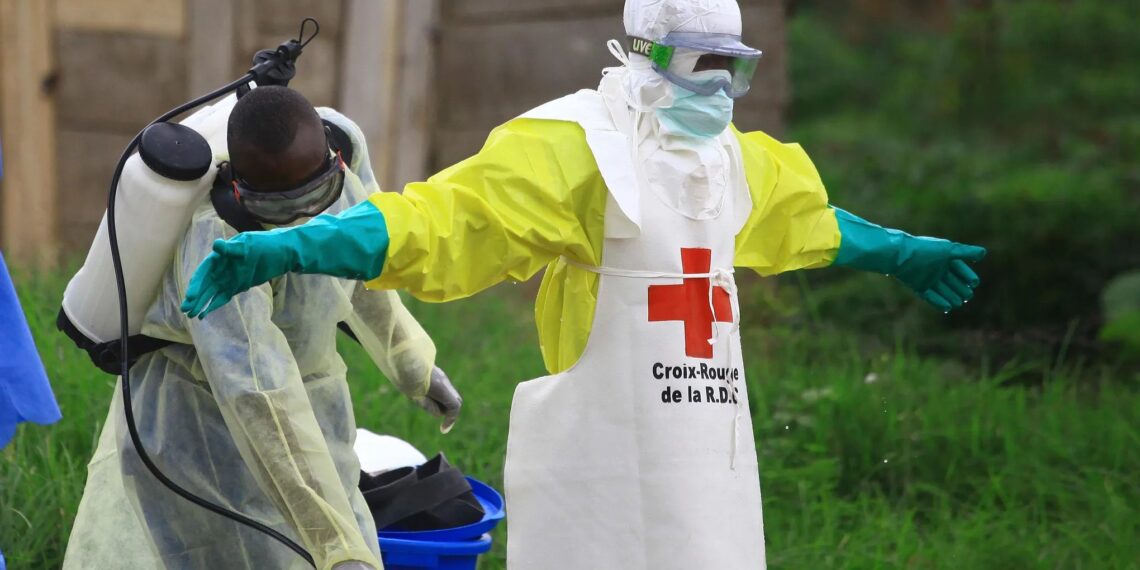 WHO health worker in protective gear during Ebola response in DR Congo