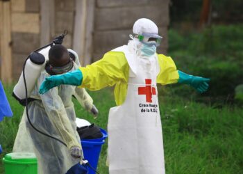 WHO health worker in protective gear during Ebola response in DR Congo
