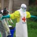 WHO health worker in protective gear during Ebola response in DR Congo